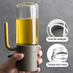 Borrifador de azeite elegante com corpo cinza e recipiente de vidro cheio de azeite, detalhes de anel de vedação e tampa com rosca